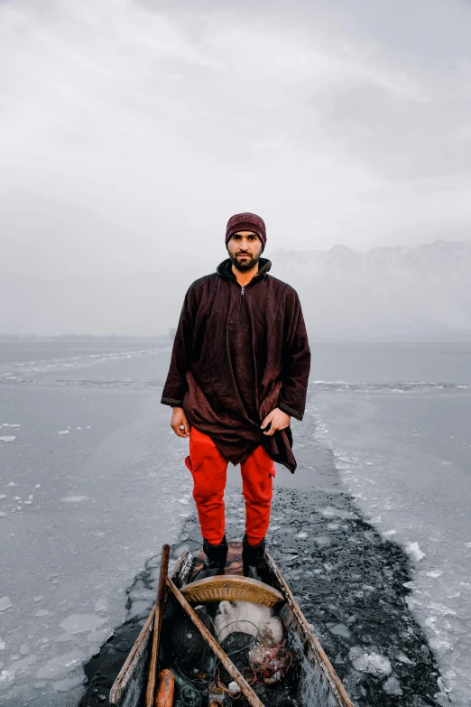 the man is standing on the ice in his pants