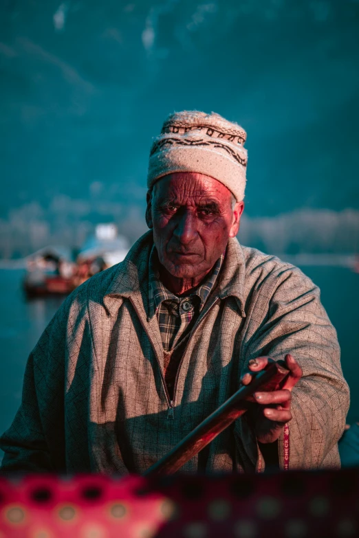 man standing on dock holding an umbrella in his hands