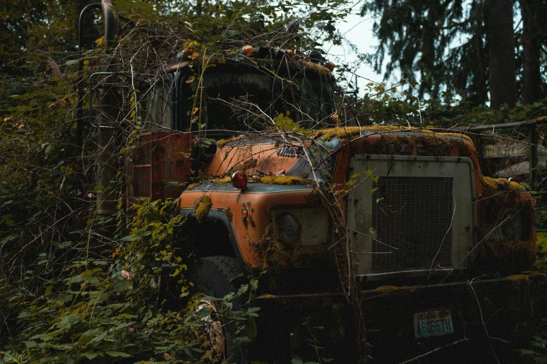 a close up of the rusted out front of a big old truck