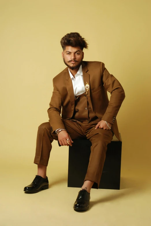 a man sitting on top of a square chair