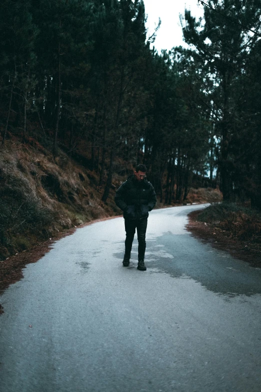 a person standing on the road in the rain