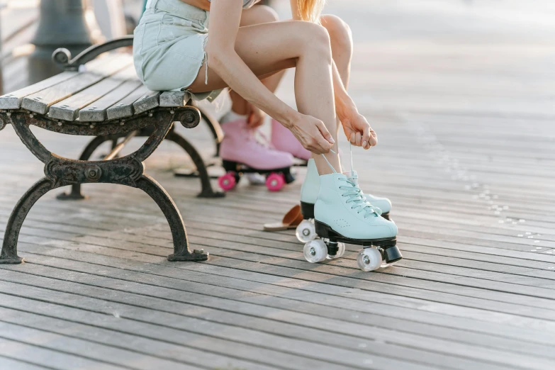 a woman sits on a bench as she roller skates with roller blades in her feet