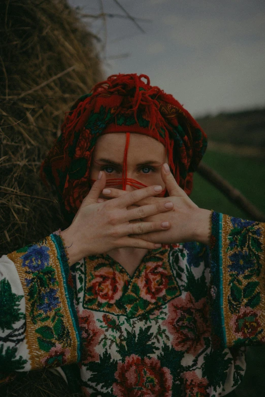 a woman covers her face with her hands