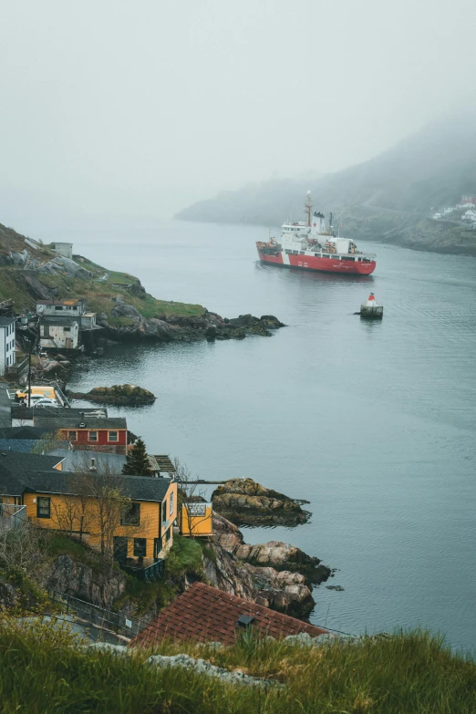 a fishing boat is in the water near a harbor