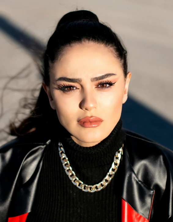 a woman wearing a black top and red jacket