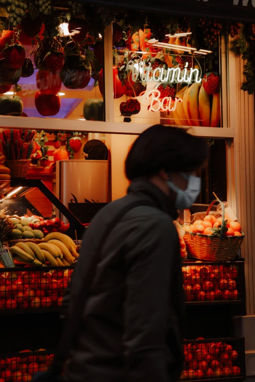 man wearing a face mask while walking in front of store