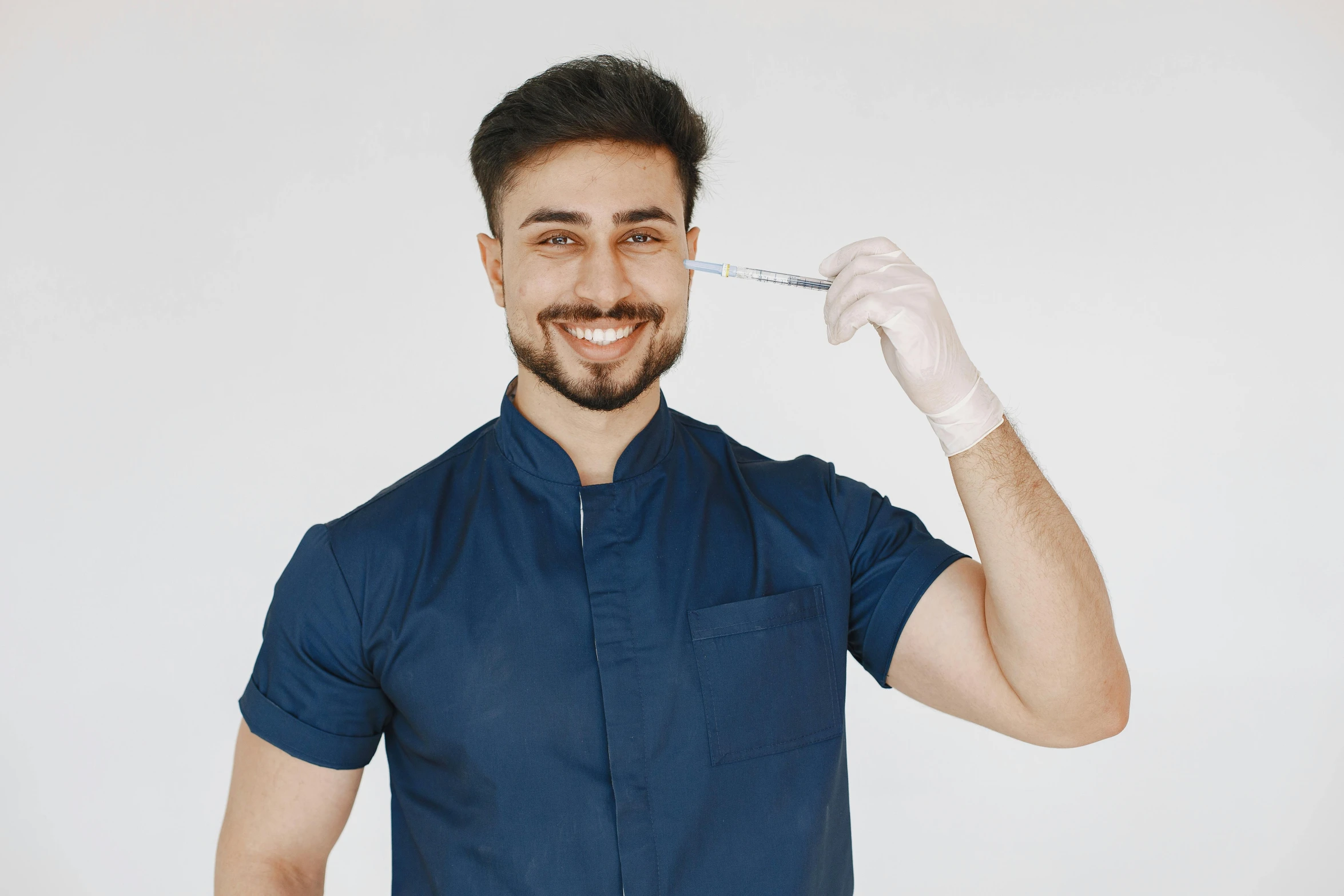 a man holding an inhaler to his mouth with white gloves on