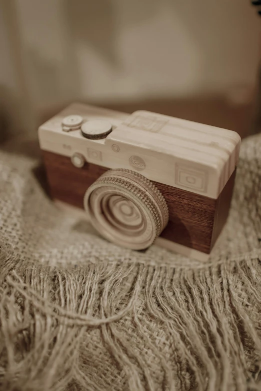 a camera sitting on a pillow near a light