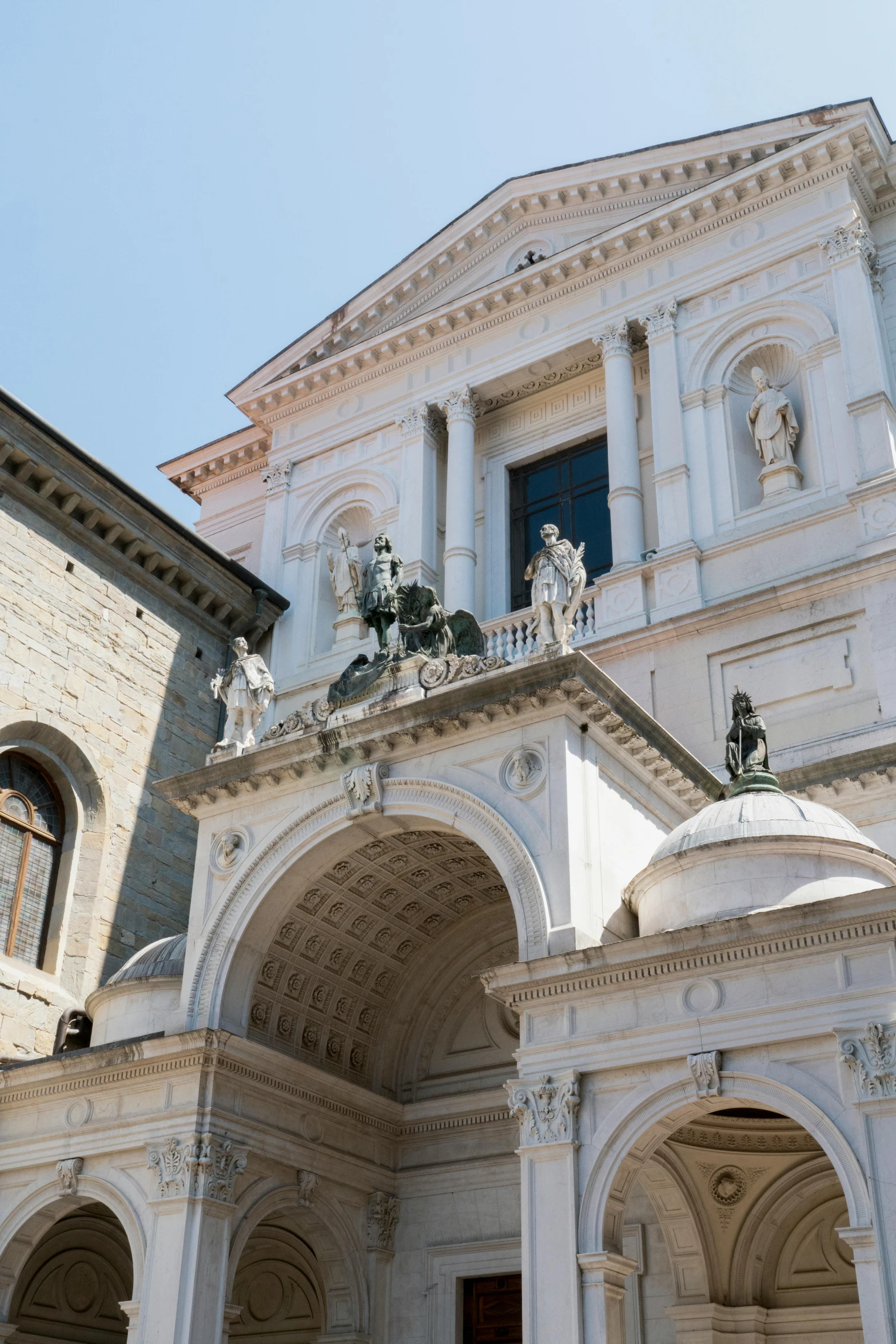 a stone building has statues on top of it