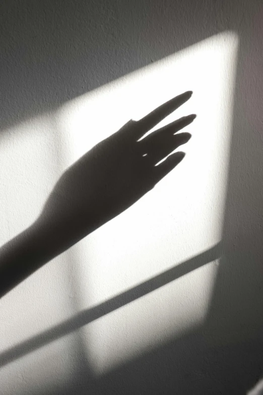 this is a shadow of a hand across the corner of a window