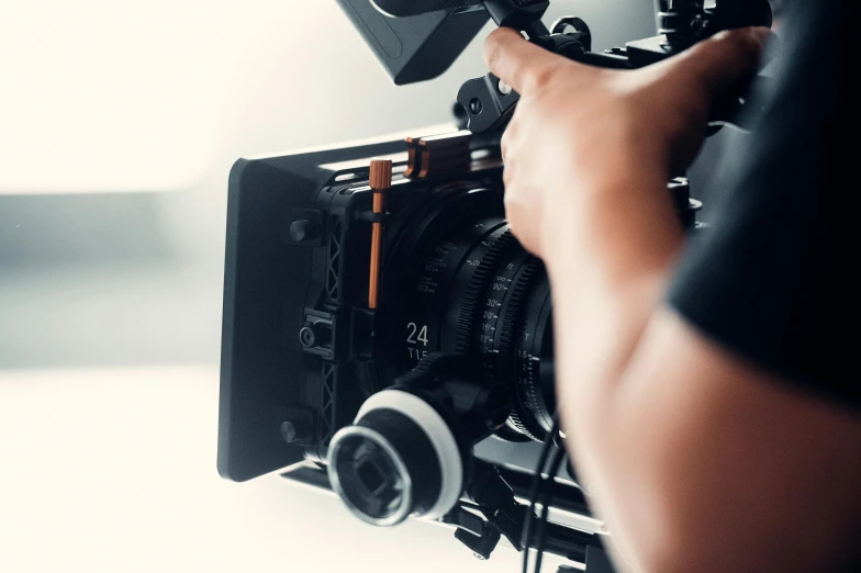 a man in black shirt holding up a camera