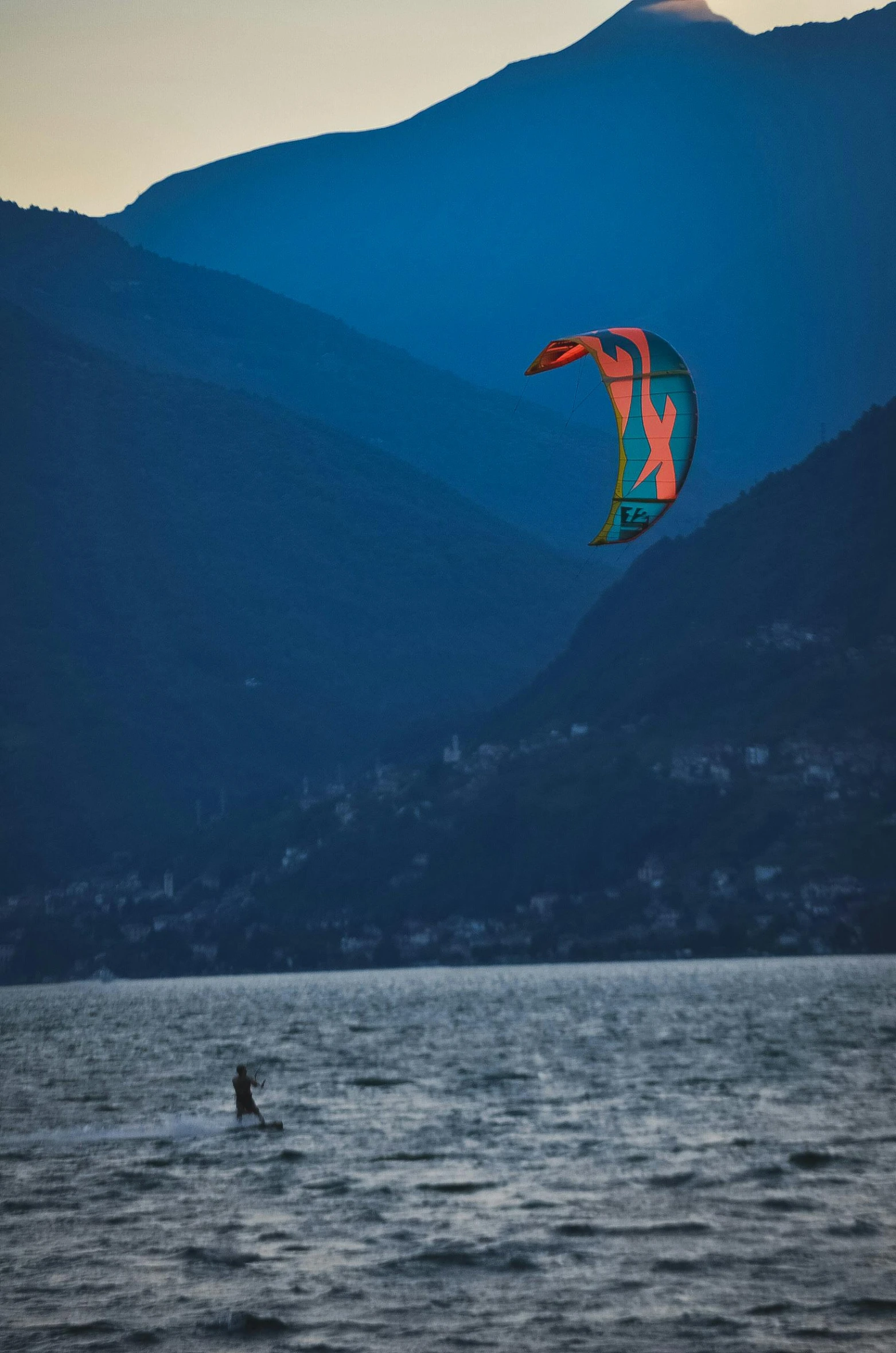 people in the water holding onto a parachute