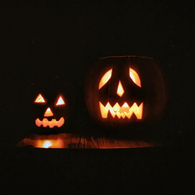 some pumpkins with glowing faces on their faces