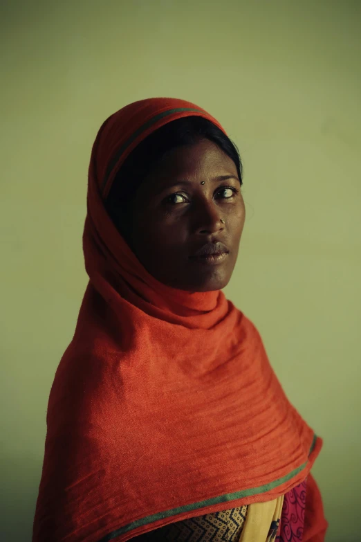 an african girl wearing a red veil in an african country