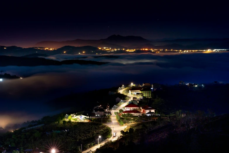 a city at night, with clouds above and below