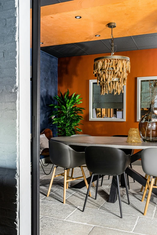 an open dining room area with modern chairs