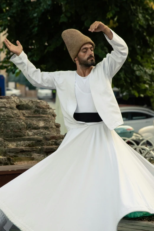 man wearing traditional dress is doing a dance