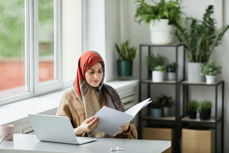 woman sitting at a desk working on a computer