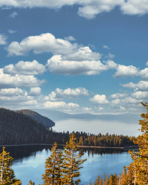 the view of a lake near the mountains is clear