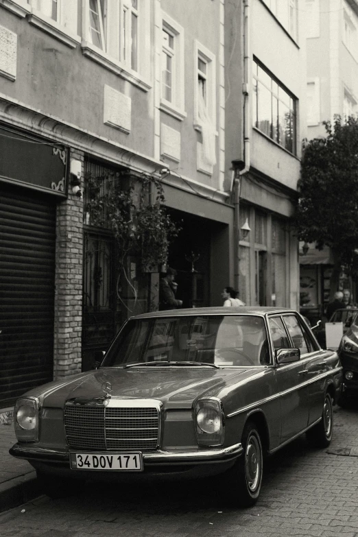 a couple of parked cars are near an alley