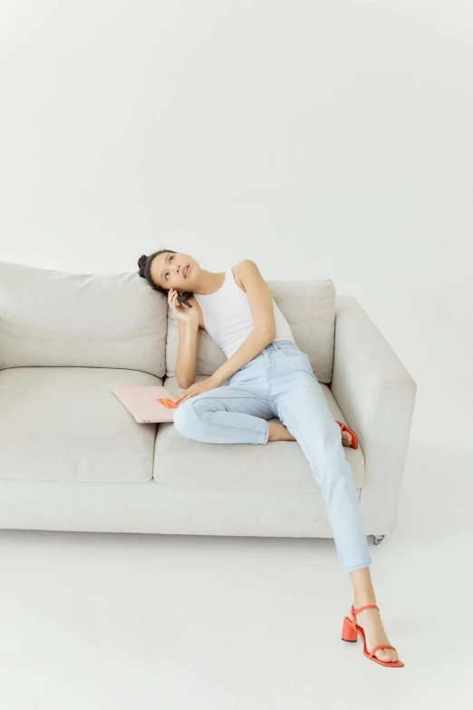 a beautiful woman sitting on a couch with her eyes closed