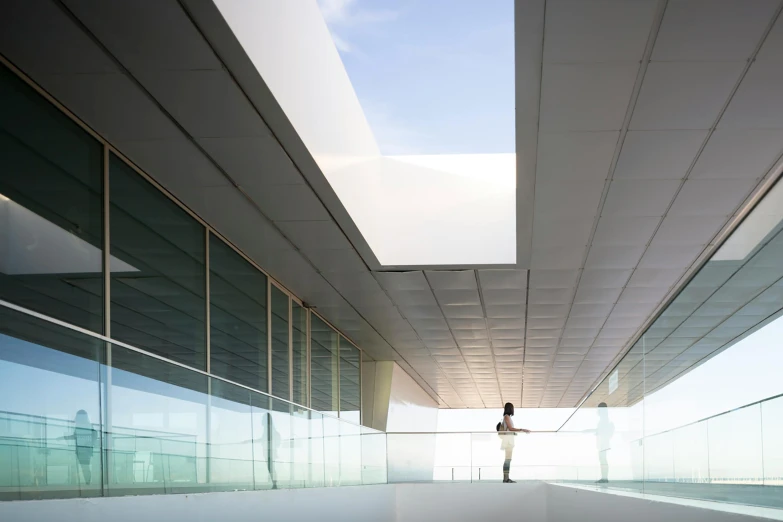 a person standing in a walkway between two buildings