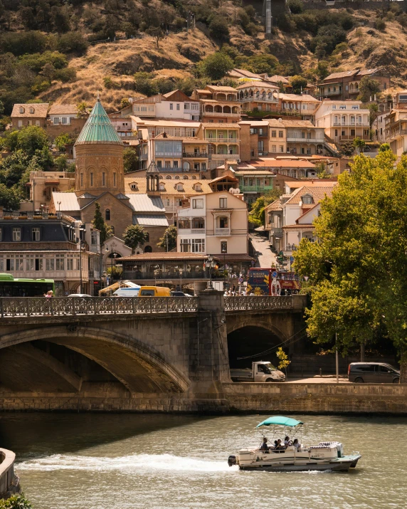 a motor boat on a river near buildings