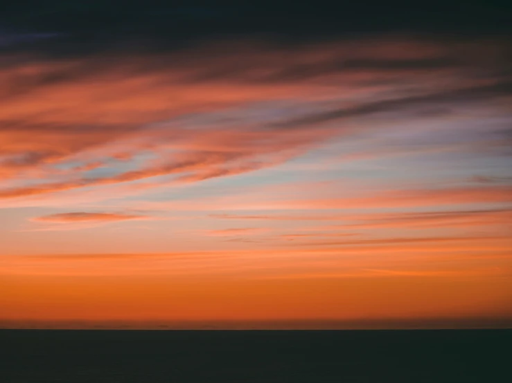 a boat is in the water at sunset