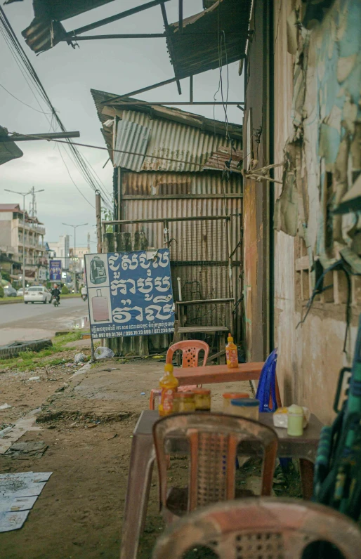 two chairs and an easel on the side of the road