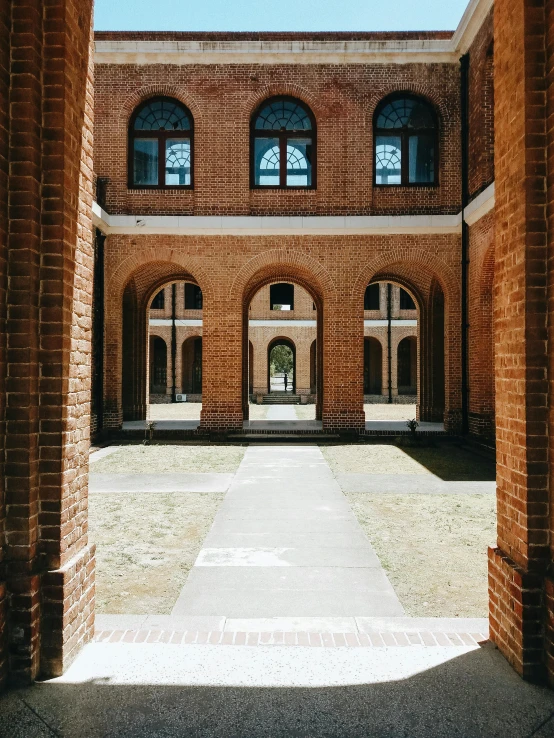 looking through two brick archways into the building