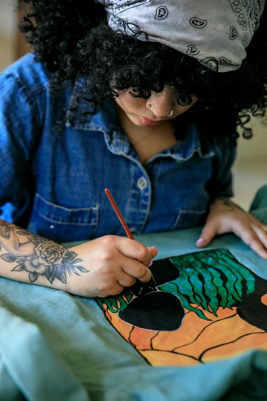 a girl sitting down coloring her cartoon pictures