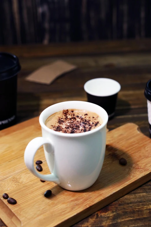 the cup is filled with  chocolate and surrounded by coffee beans