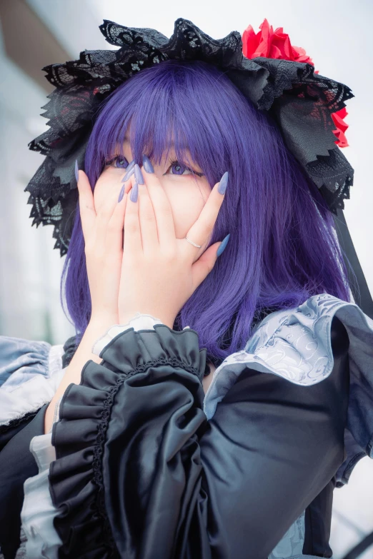 a girl with long purple hair has a ring around her finger