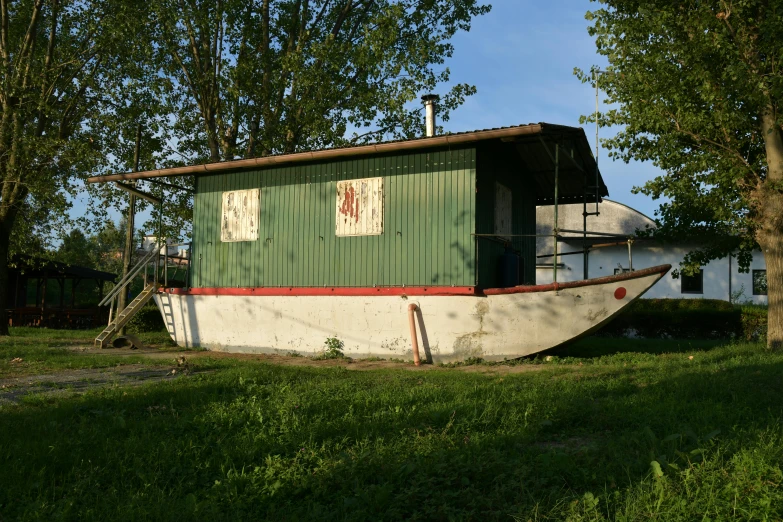 the old boat is parked beside the house