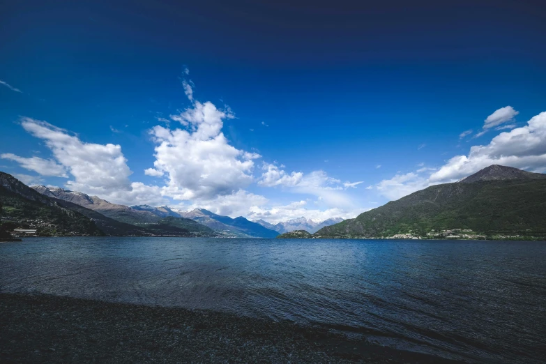 a lake and mountain with the mountains in the background