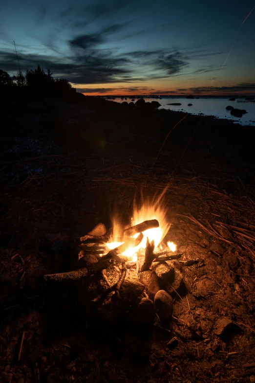 a campfire glowing bright in the dark