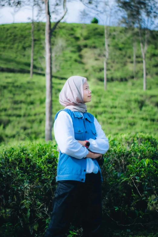 a person is standing in a field near trees