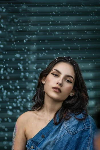 a girl in a denim dress in the rain