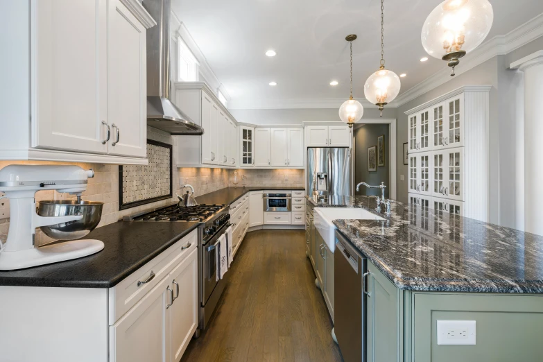 this kitchen is very clean and has marble counter tops