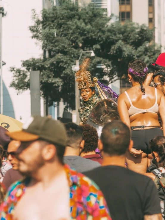 some women dressed in costumes and hats walking through a crowd