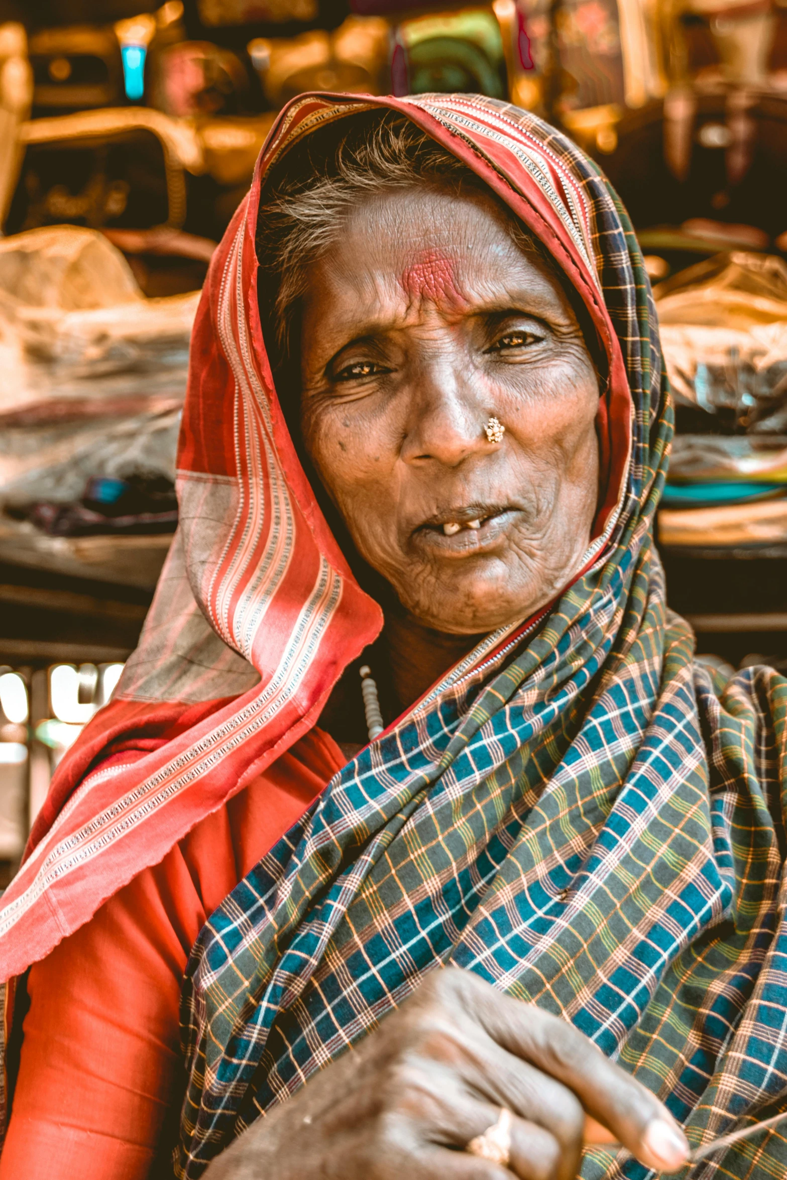 an older woman in a sari poses for the camera