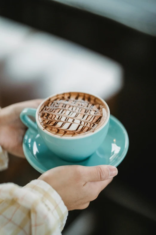 a person holding a cup of  chocolate