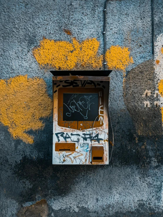 a black box and yellow paint are on the ground