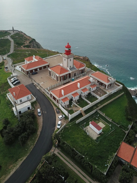 an aerial view of a big building next to some water