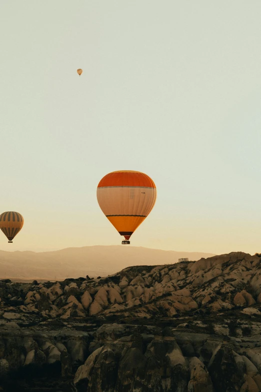 a couple of  air balloons are flying