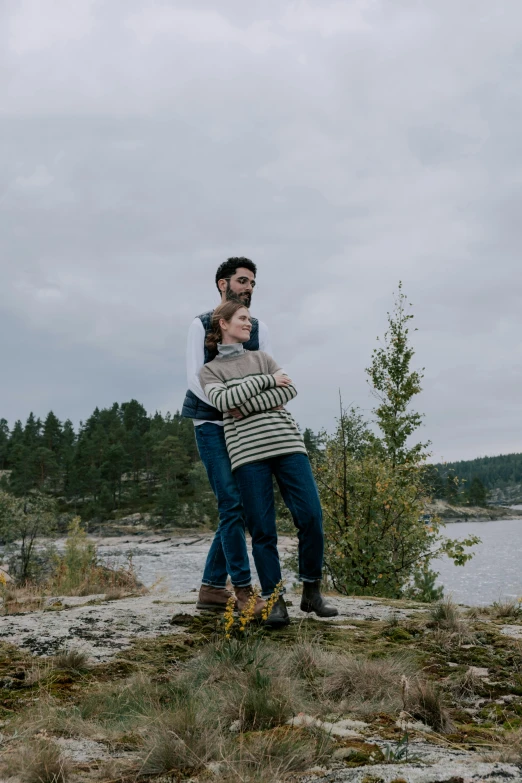 two people standing with their arms around each other