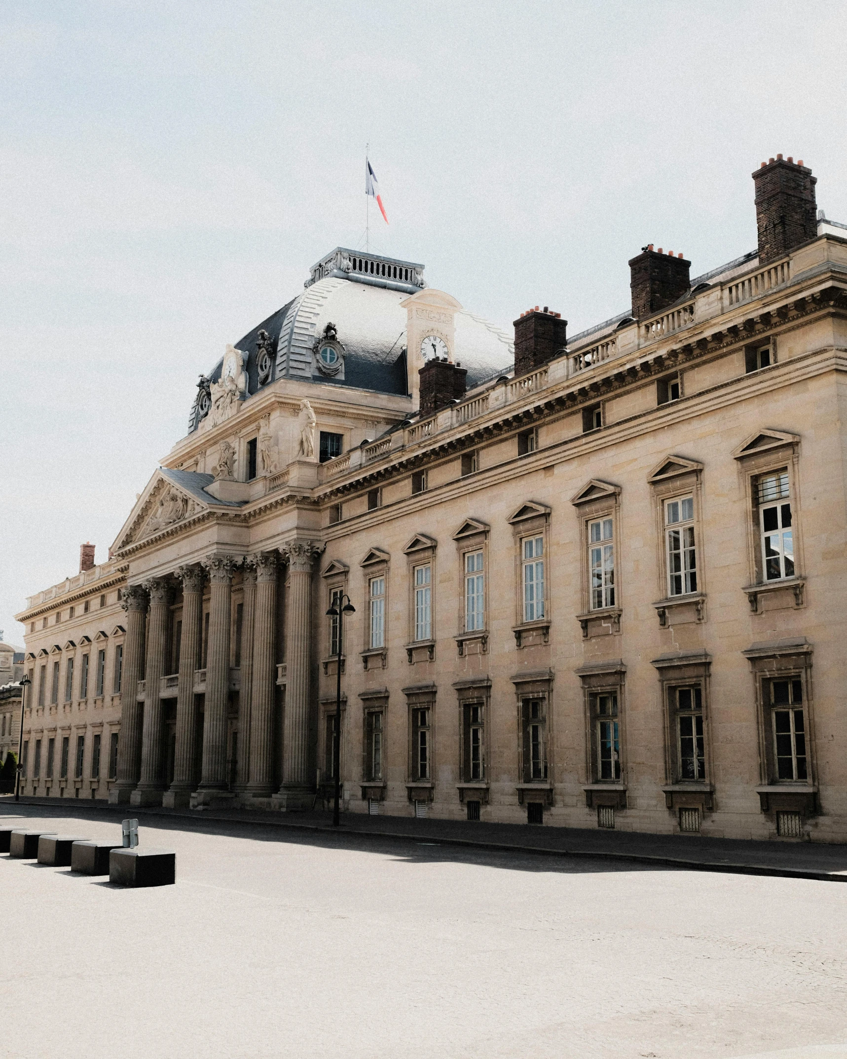 a very large building sitting on the corner of a sidewalk