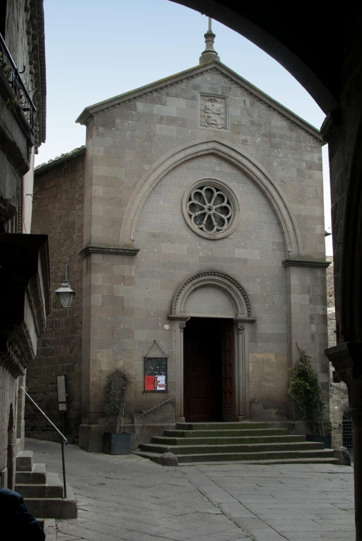 the entry way to a stone church, through an arch