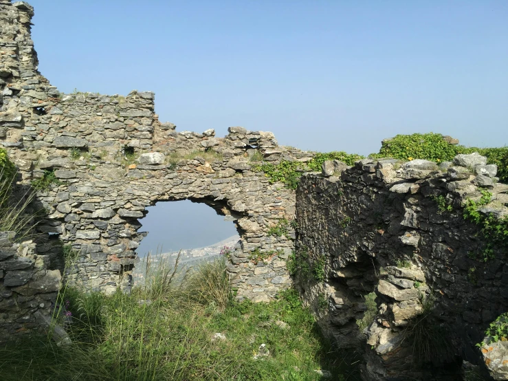 an old, stone building with the doors partially open