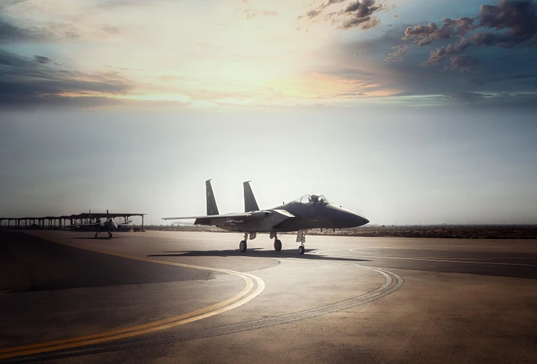 a fighter jet is parked in the sun on a runway